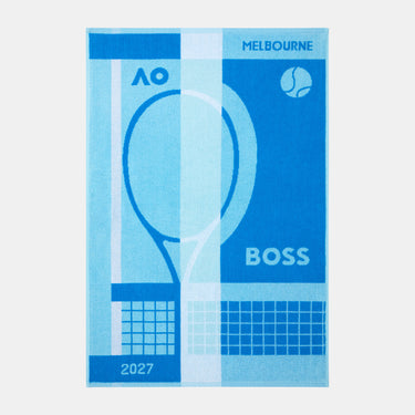 A rectangular blue and light blue towel featuring a tennis racket graphic, the text 'MELBOURNE', 'BOSS', 'AO', and '2027', with a tennis ball icon in the top right.