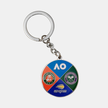 A silver metal keychain featuring a circular enamel medallion with four quadrants representing the Australian Open Tennis Championships, including the AO logo, Roland Garros, Wimbledon, and US Open branding.