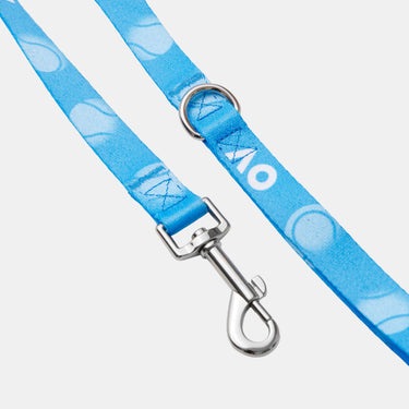 A light blue dog leash with a white circular pattern, a silver metal D-ring, and a silver swivel snap hook clasp, shown on a plain white background.