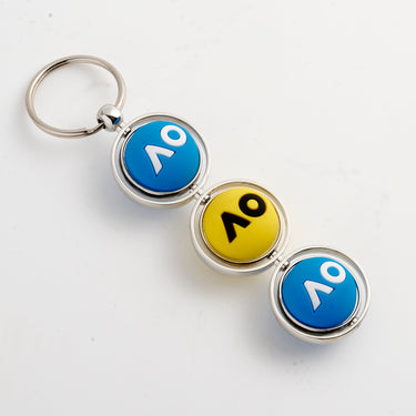 A keyring with three spinning tennis balls, predominantly blue and yellow in color with AO logo in white or black, attached to a keyring.