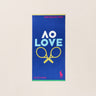 Navy towel with 'AO Love' and tennis racket design, bright pink iconic Polo Ralph Lauren logo on a beige background