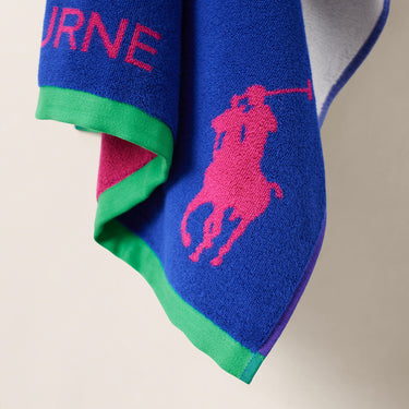 Navy Ralph Lauren Towel with signature polo player icon in bright pink against a neutral background. 