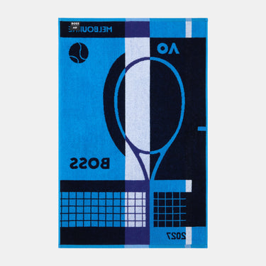 A rectangular area rug with a bold, graphic tennis-themed design in bright blue, navy, and white. The design features a stylized tennis racket, a tennis ball, and the text 'BOSS' and 'MELBOURNE 2025'.