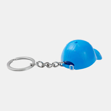 A small blue novelty cap-shaped keychain with a silver metal split ring and chain, shown on a plain grey background.