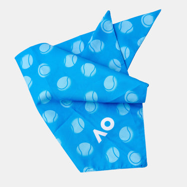 A bright blue bandana featuring a white tennis ball pattern and a white stylized 'AO' logo, folded on grey background.