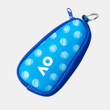 A blue neoprene zippered pouch with a tennis ball pattern and a white 'AO' logo, featuring a silver keyring attachment on a white background.