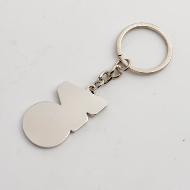 Backside of keychain in the shape of the AO logo in silver with split key attachment and a chain.