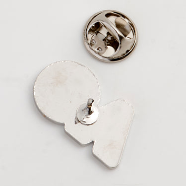 Back side of a lapel pin in the shape of the AO logo in silver, designed for attachment to clothing or accessories.