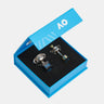 Two miniature silver trophy pendants with blue and gold accents are displayed inside an open bright blue presentation box with a black velvet lining. The brand logo 'AO' is visible on the inner lid and the base of the trophies.